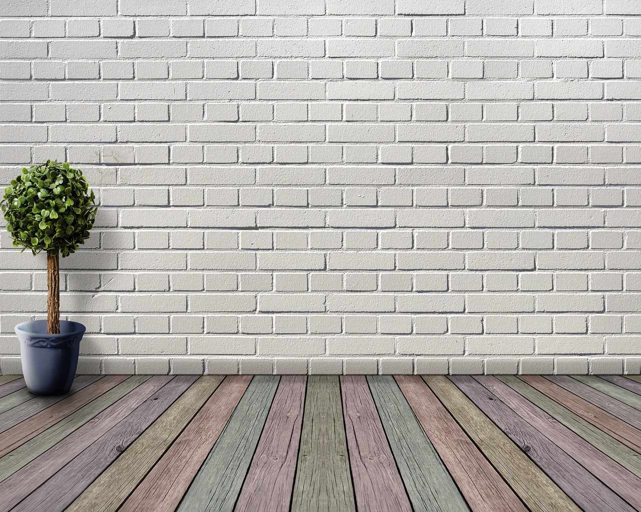 Empty room with white brick walls and a wood floor