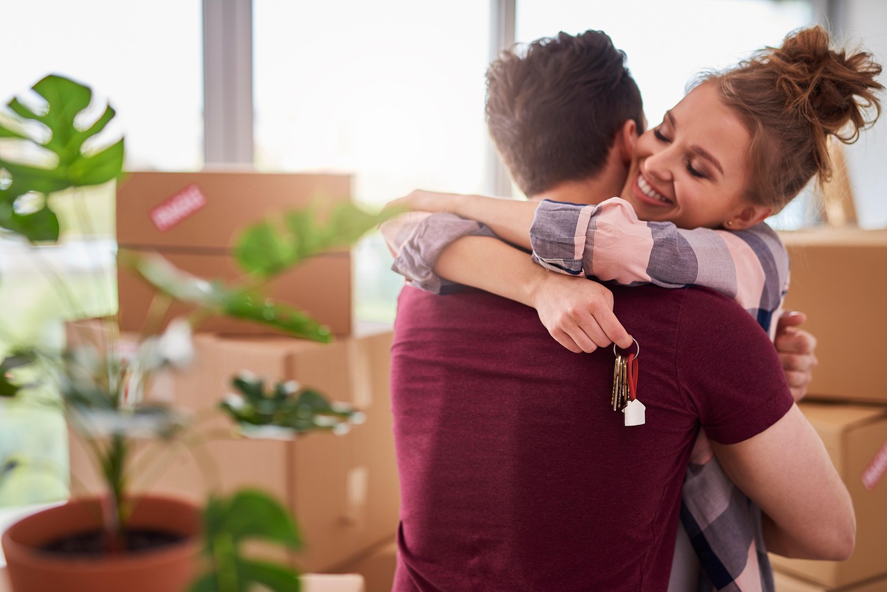 Couple celebrating among moving boxes in a new home